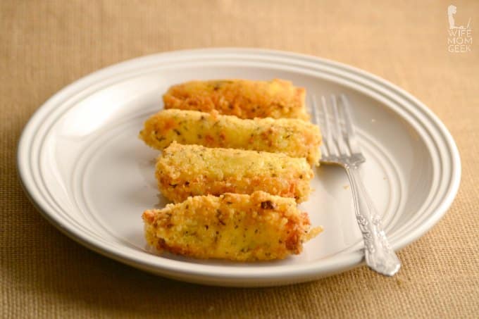 parmesan covered low carb cheese sticks on a white plate