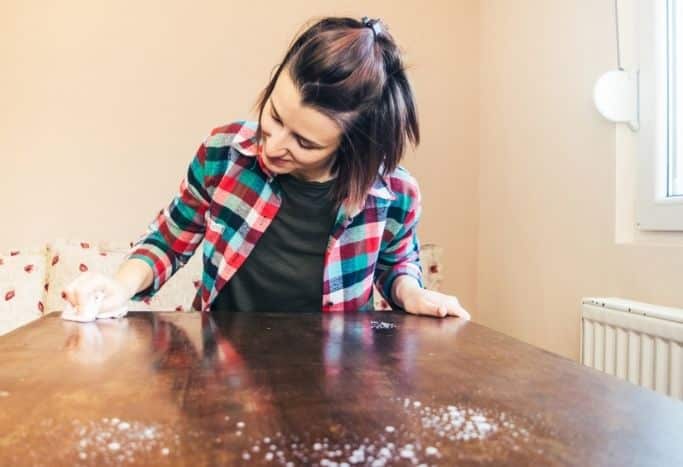 woman wiping down a table