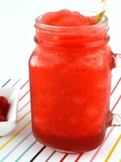 cherry slushie in mason jar glass