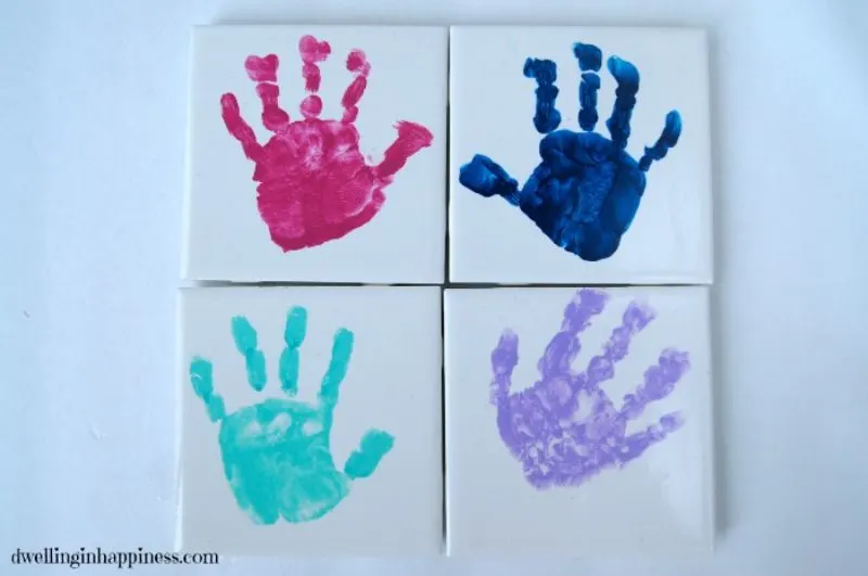 4 handprint coasters arranged in a square