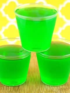 three lime and tequila jello shots stacked