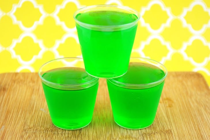 three lime and tequila jello shots stacked