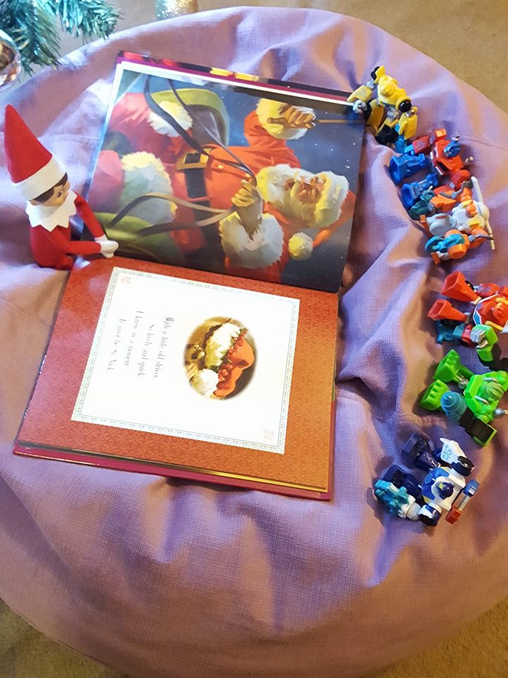 Elf reads The Night Before Christmas to the Transformers