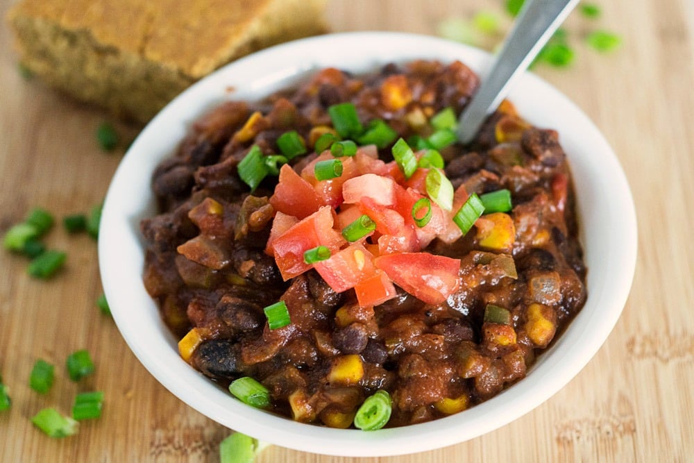 vegan black bean and corn chili with a slice of cornbread