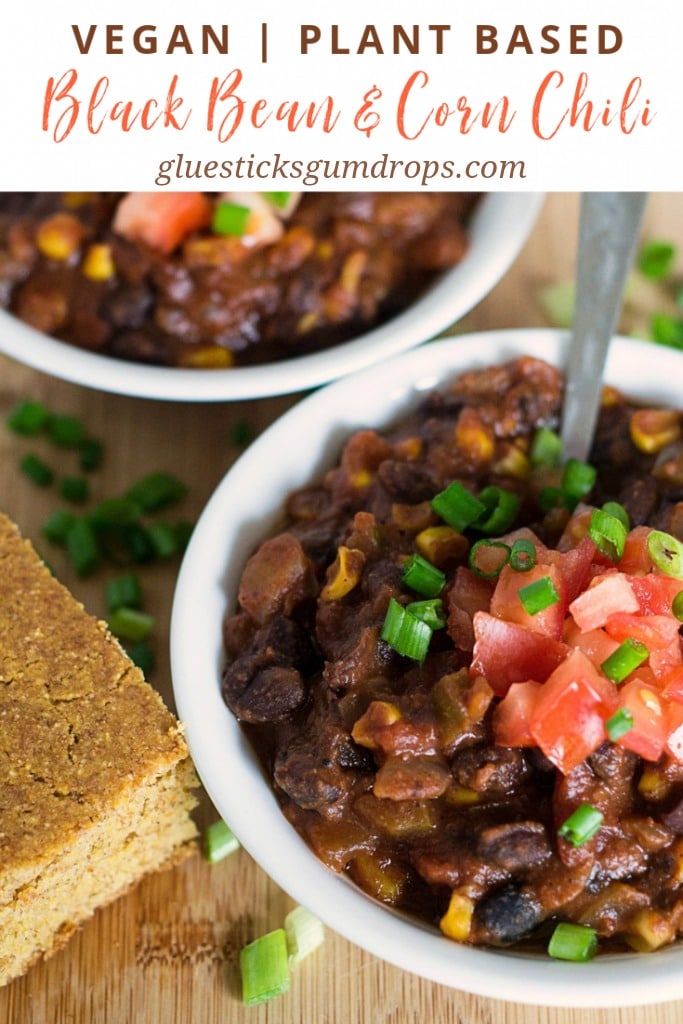 two bowls of vegan black bean and corn chili with cornbread and green onions