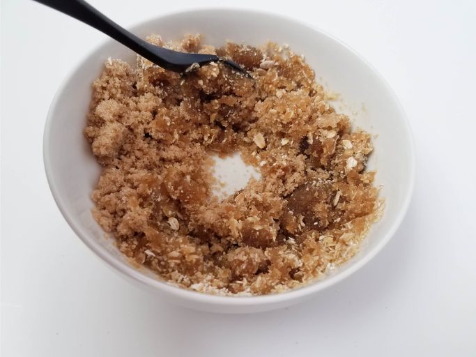 stirring brown sugar, olive oil, and ground oatmeal together in a small white bowl