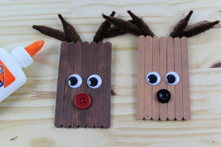 googly eyes and buttons glued to the face of the reindeer ornaments