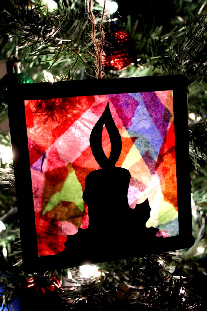 stained glass ornament hanging on a tree