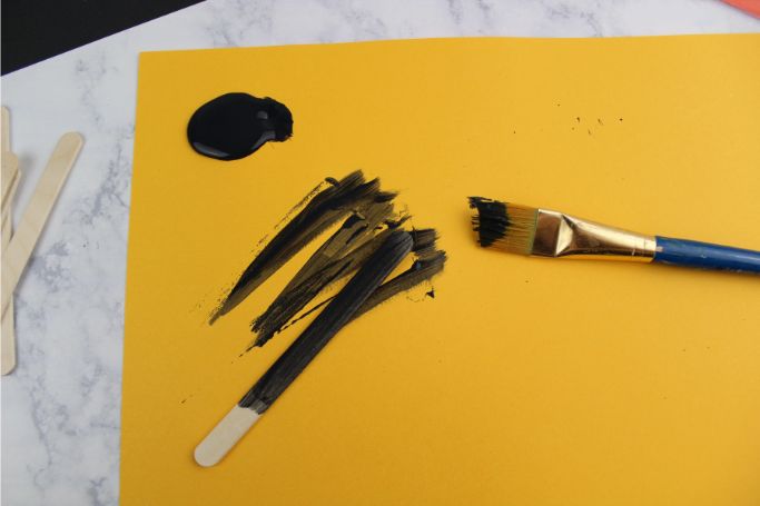 painting popsicle sticks black