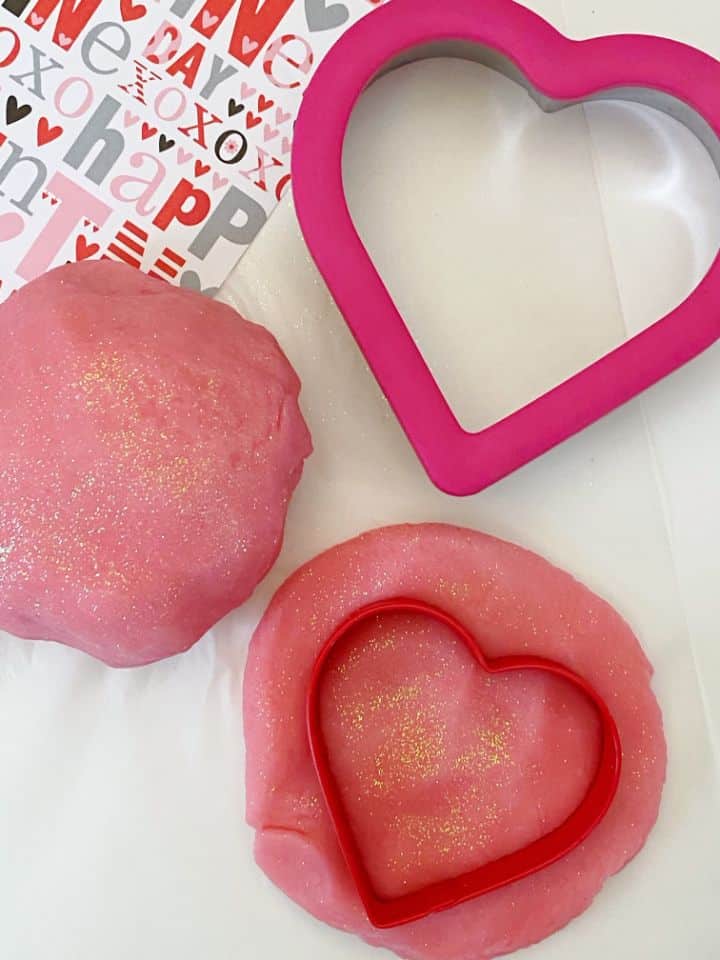 pink playdough with heart shaped cookie cutter vertical