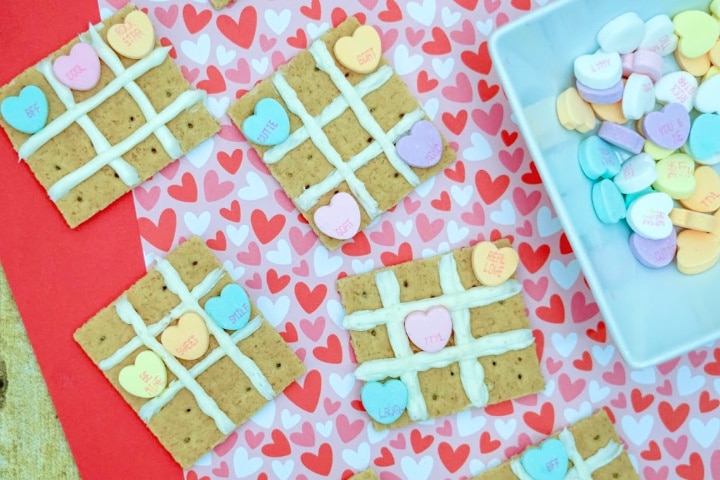 finished valentine's day tic tac toe snacks on a heart background