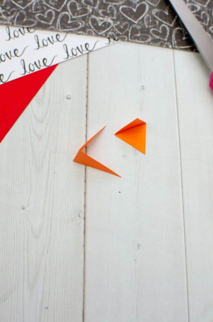 orange paper folded to make beaks