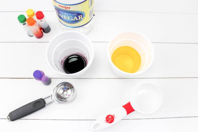 food coloring and vinegar added to cups