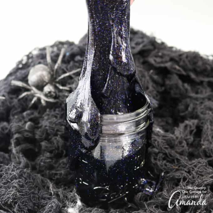 black glitter slime in a jar