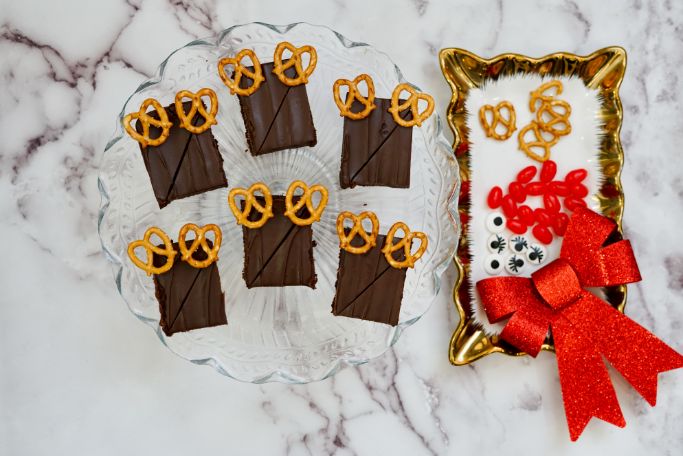 brownies are cut into rectangles with pretzel antlers in place