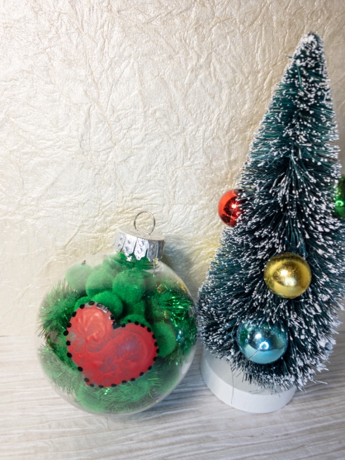 final vertical grinch ornament beside miniature Christmas tree