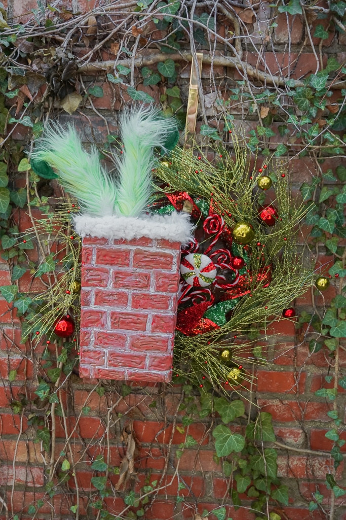 grinch in chimney wreath for Christmas