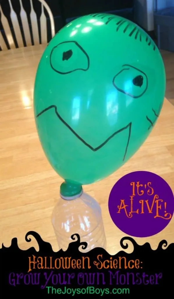 green balloon with monster face on bottle of baking soda vinegar solution