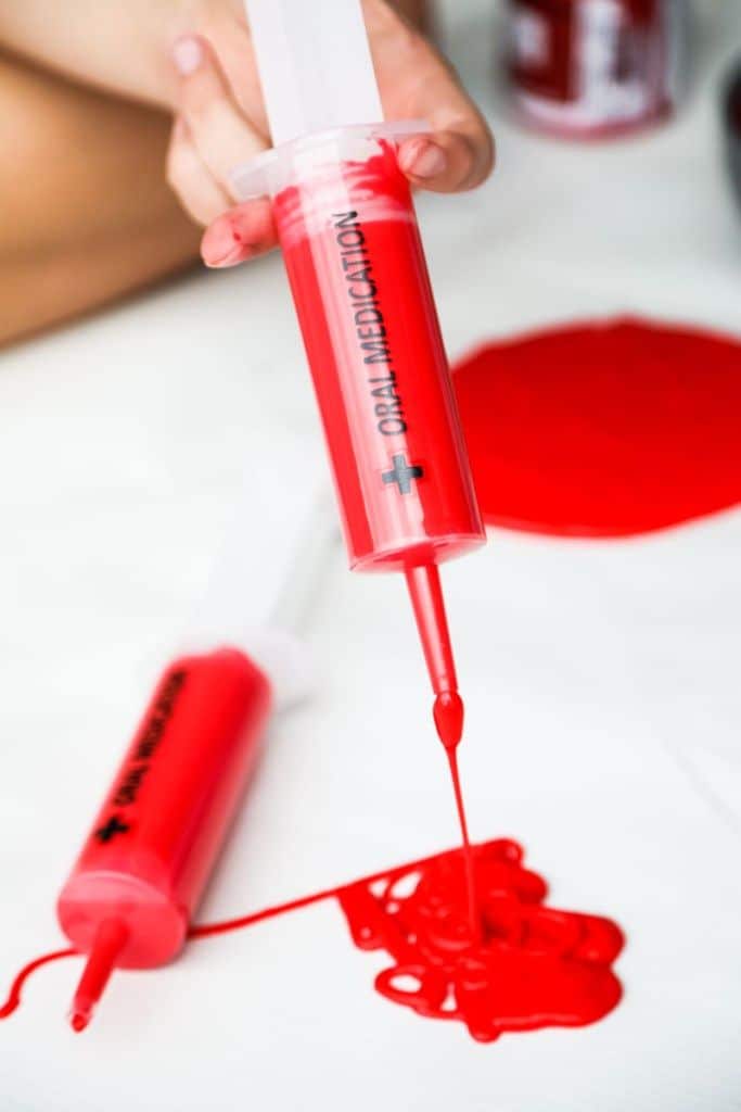 red slime in a syringe to look like oozing blood
