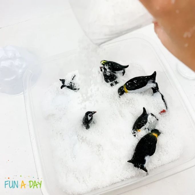instant snow and penguin sensory bin