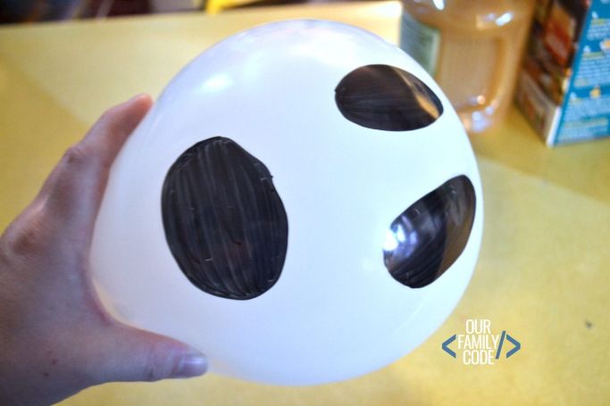 balloon with ghost face used in an experiment