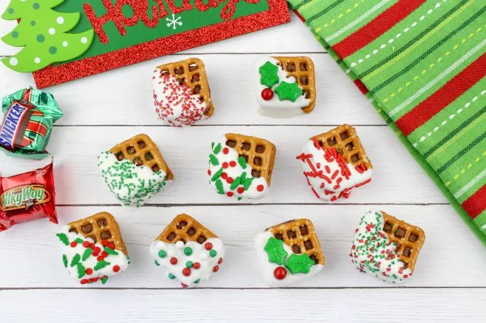 festive chocolate pretzel bites on white wood background