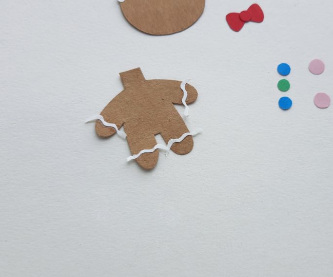 gingerbread man arms and legs decorated with curvy white strips