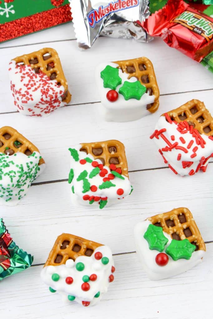 holiday pretzel bites - chocolates sandwiched between square pretzels and decorated
