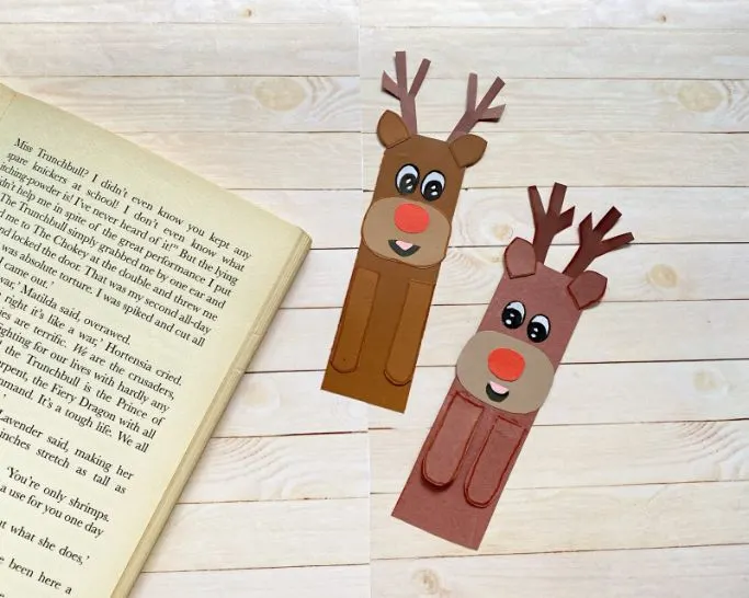 two reindeer bookmarks with book on fake wood background