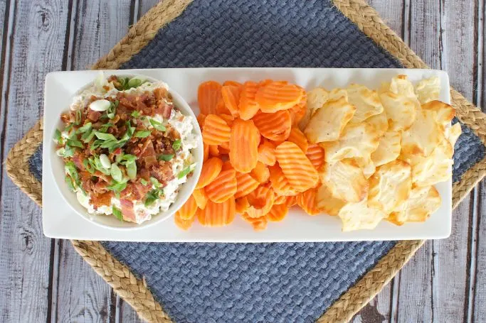 overhead picture of the bacon pickle dip recipe served with sliced carrots and crackers