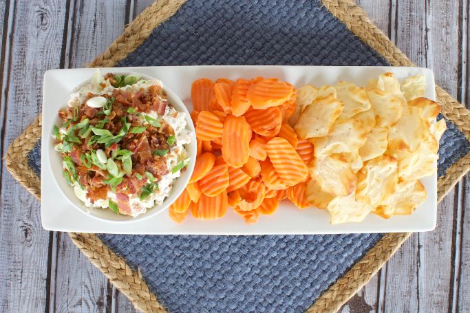 overhead picture of the bacon pickle dip recipe served with sliced carrots and crackers