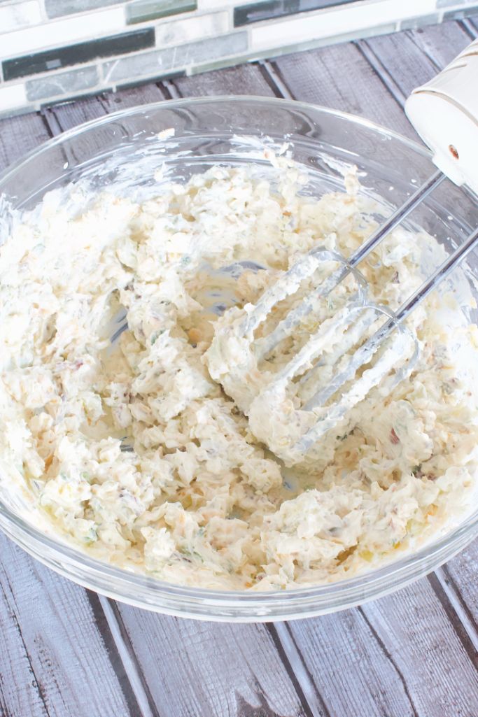 combining the pickle dip ingredients with a hand mixer