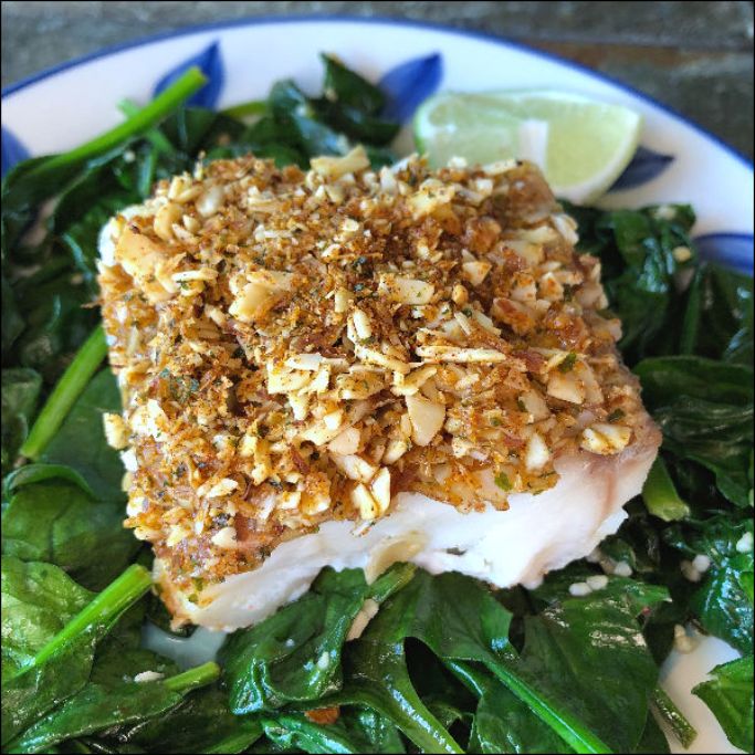 almond crusted cod on a bed of spinach