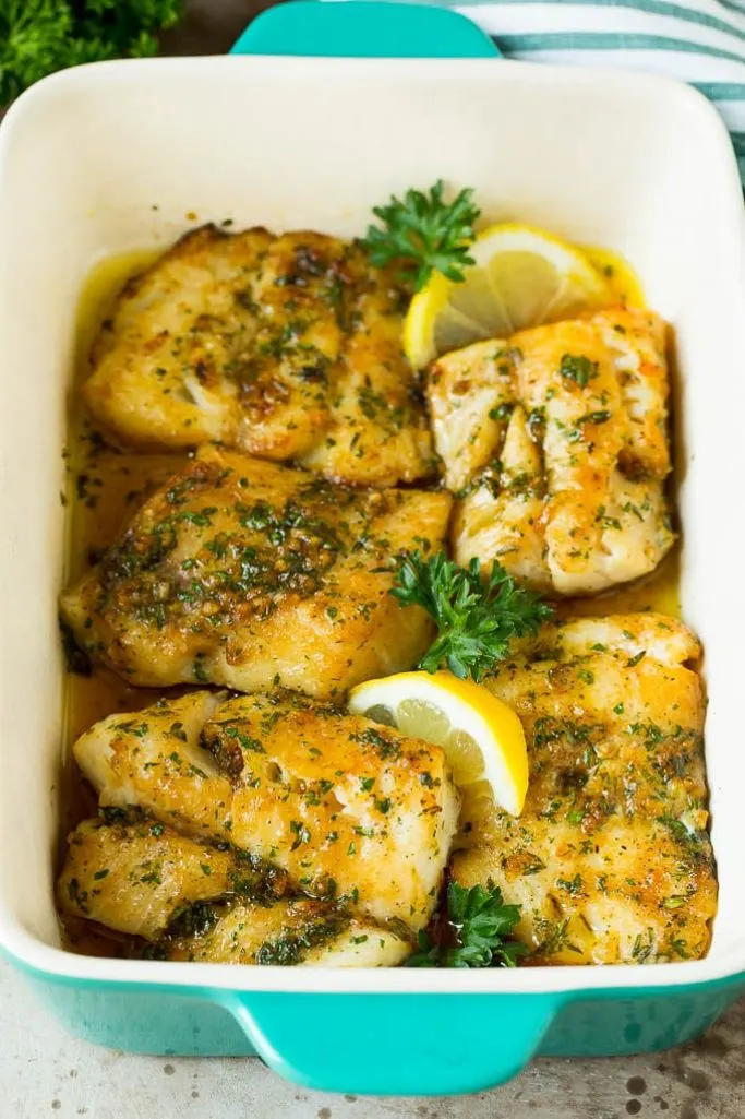 baked cod with garlic and herbs in white dish
