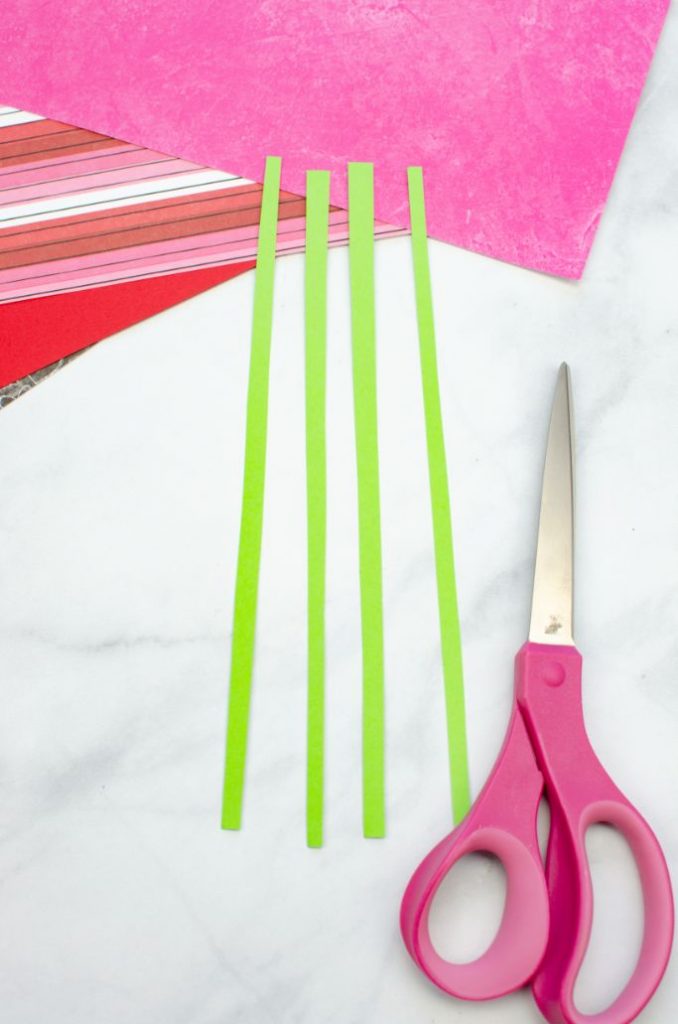 cut green paper strips for flower stems