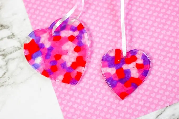 two heart suncatchers on pink paper background