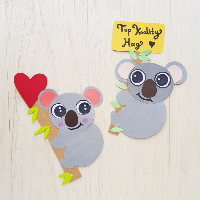 two koalas clutching eucalyptus branches with Valentine's Day messages
