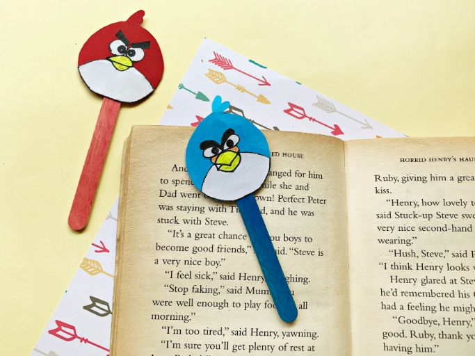 red and blue angry birds bookmarks on book