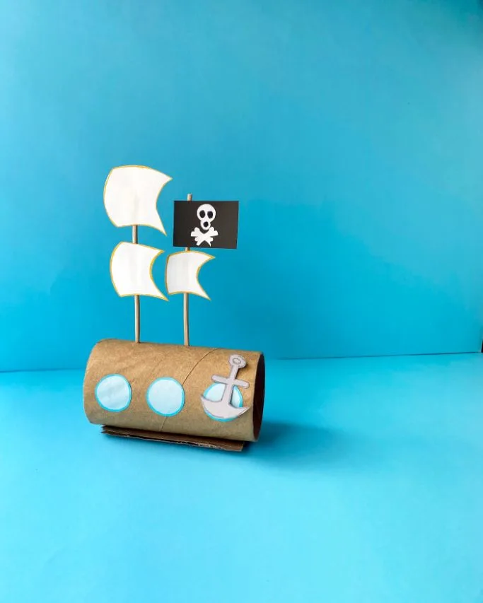 completed pirate ship craft for kids on blue background