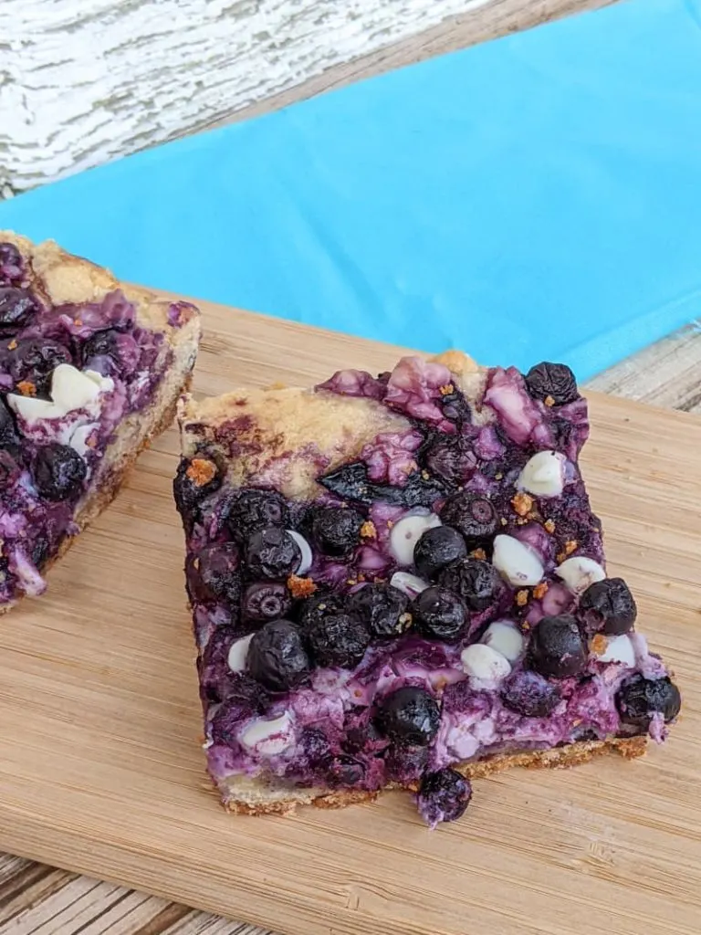 cream cheese blueberry bars on cutting board