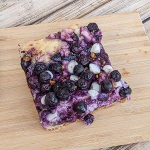blueberry cream cheese bar on a cutting board