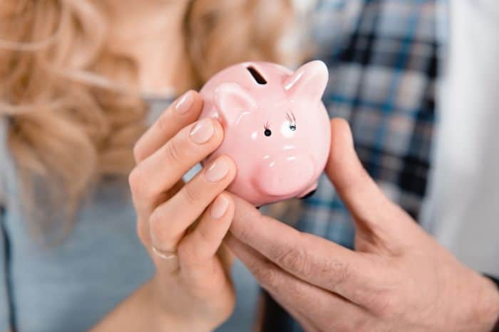 small piggy bank being held by a couple