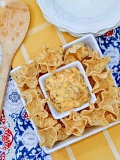 easy rotel dip on white serving platter with colorful napkins underneath
