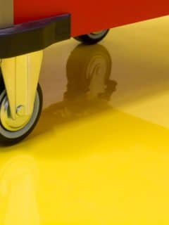 wheels of a cart on yellow epoxy floor
