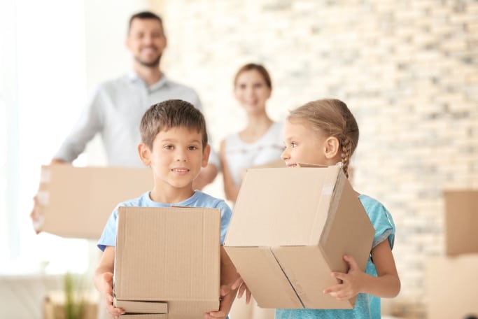 children and parents with boxes