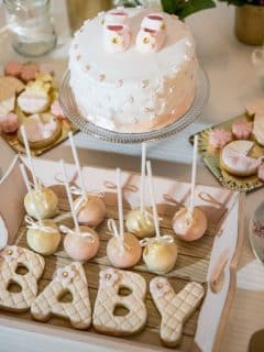 dessert table at a baby shower - cake pops, cookies, cake