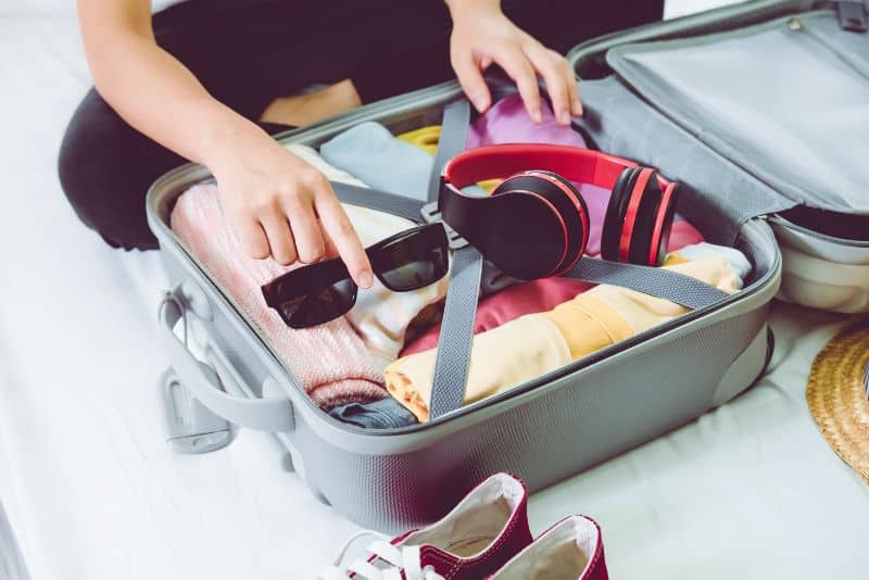 clothes neatly packed in suitcase using the rolling method