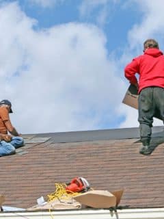 men repairing a roof