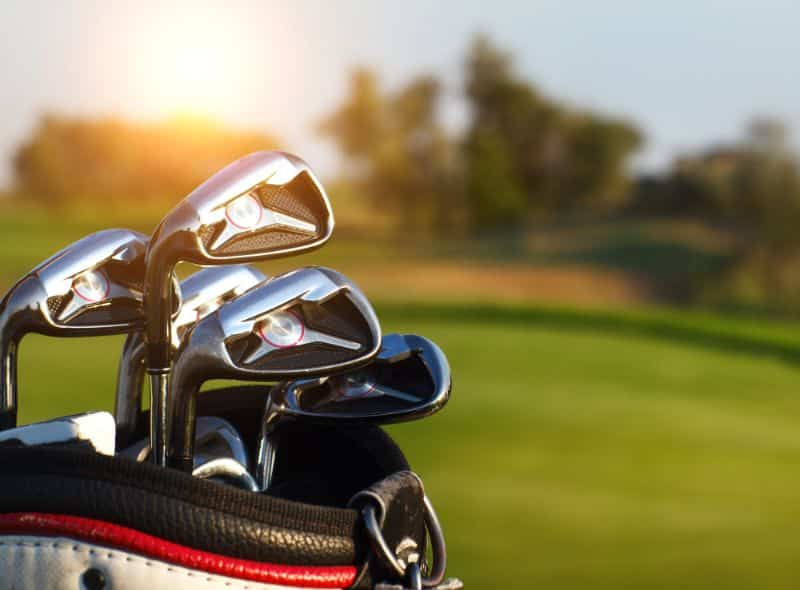 golf clubs gleaming in the sunset