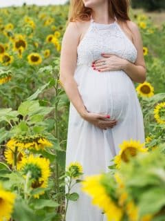 pregnant woman among sunflowers
